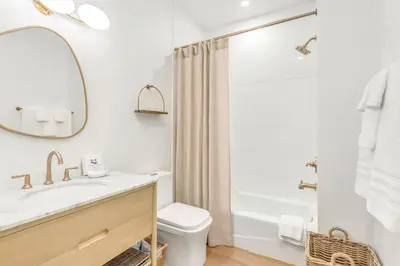 a bathroom with a sink and a toilet and a mirror at Psalms in Santa Rosa Beach