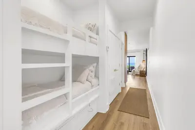 a white bedroom with white walls and white shelves at Psalms in Santa Rosa Beach