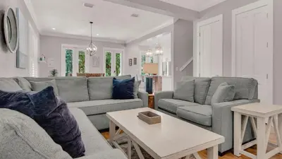 a living room with two couches and a table at Magnolia Breeze in Santa Rosa Beach