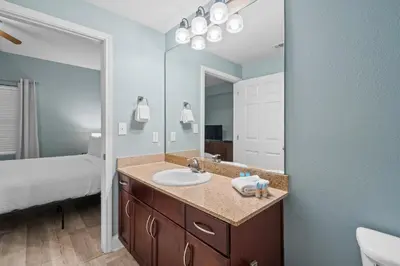 a bathroom with a sink and a large mirror at Resort-Style Lake-View Condo, 5 Pools, Hot Tubs, Walk to Beach in Panama City Beach