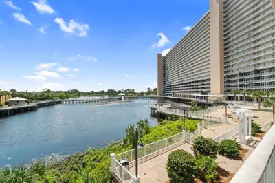 a view of a river next to a building at Resort-Style Lake-View Condo, 5 Pools, Hot Tubs, Walk to Beach in Panama City Beach