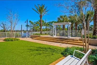 a park with a white bench and a gazebo at Resort-Style Lake-View Condo, 5 Pools, Hot Tubs, Walk to Beach in Panama City Beach