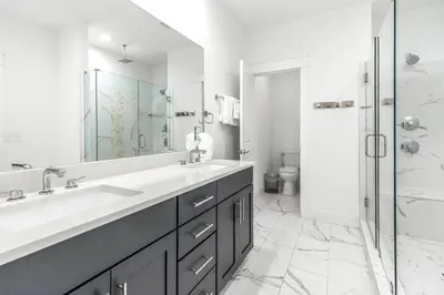 a white bathroom with a sink and a shower at Salty Sons in Inlet Beach