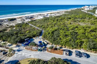 an aerial view of a beach with cars parked at Salty Sons in Inlet Beach