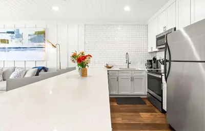 a kitchen with a white counter top and a refrigerator at The Palms in Santa Rosa Beach