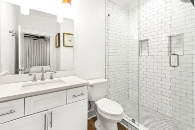 a white bathroom with a toilet and a shower at The Palms in Santa Rosa Beach
