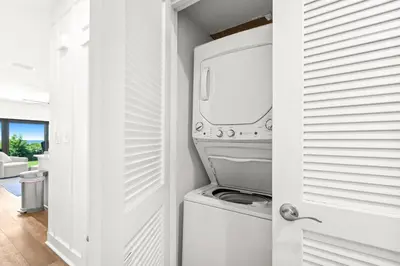 a white laundry room with a washer and dryer at The Palms in Santa Rosa Beach