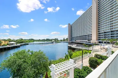 a view of a river with a building and a bridge at Lake-View Condo Near Beach,5 Pools, 2 Hot Tubs, Balcony & Resort Amenities in Panama City Beach