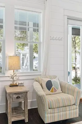 a living room with a chair and a table at Om Sweet Om in Seagrove Beach