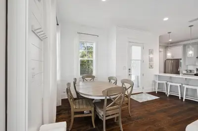 a kitchen and dining room with a table and chairs at Om Sweet Om in Seagrove Beach