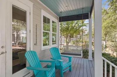 two chairs on the front porch of a house at Om Sweet Om in Seagrove Beach