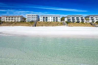 a view of the beach with condos in the background at Seagroovy in Seagrove Beach