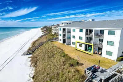an aerial view of a building and the beach at Seagroovy in Seagrove Beach