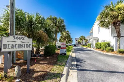 a street sign for a beachside street with palm trees at Seagroovy in Seagrove Beach