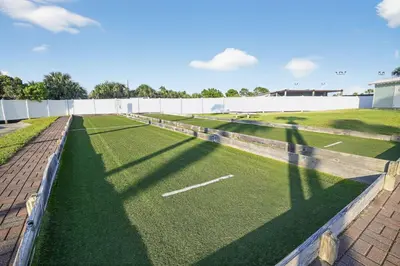 a baseball field with green grass and a fence at Oceanfront Condo - Balcony Views & Beach Access in Panama City Beach