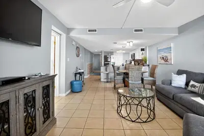 a living room with a couch and a table at Oceanfront Condo - Balcony Views & Beach Access in Panama City Beach