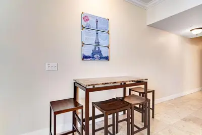 a table and four chairs in a room with a wall at Tidewater 3006 by Emerald Cost Retreats in Panama City Beach