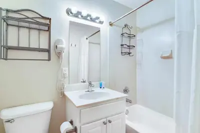 a white bathroom with a sink and a toilet at Tidewater 3006 by Emerald Cost Retreats in Panama City Beach