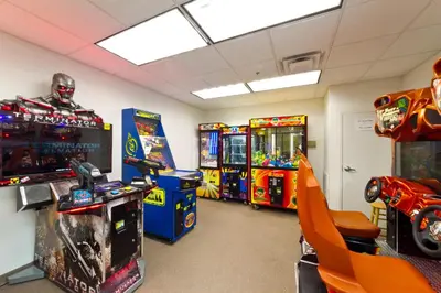 a room with several arcade games and consoles at Tidewater 3006 by Emerald Cost Retreats in Panama City Beach