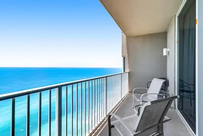 two chairs on a balcony looking out at the ocean at Tidewater 3006 by Emerald Cost Retreats in Panama City Beach