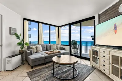 a living room with a couch and a tv at Sunbird low Floor 2BR! Free Beach Chair Service! by Dolce Vita Getaways PCB in Panama City Beach