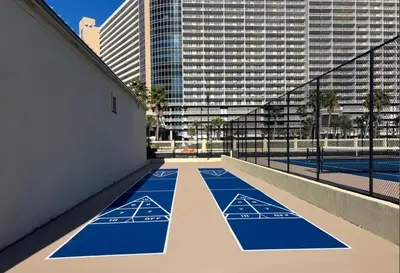 an empty tennis court in the middle of a city at Sunbird low Floor 2BR! Free Beach Chair Service! by Dolce Vita Getaways PCB in Panama City Beach