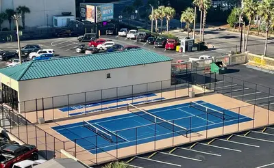 an overhead view of two tennis courts in a parking lot at Sunbird low Floor 2BR! Free Beach Chair Service! by Dolce Vita Getaways PCB in Panama City Beach