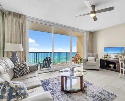 a living room with a view of the ocean at BeachFront- 5 Pools, Starbucks, Movies - Majestic Beach Resort in Panama City Beach