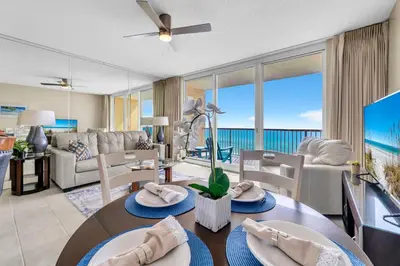 a living room with a couch and a table at BeachFront- 5 Pools, Starbucks, Movies - Majestic Beach Resort in Panama City Beach