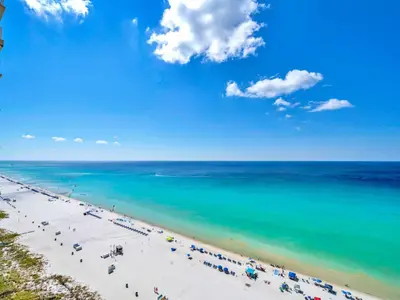 a beach with a lot of people and the ocean at BeachFront- 5 Pools, Starbucks, Movies - Majestic Beach Resort in Panama City Beach
