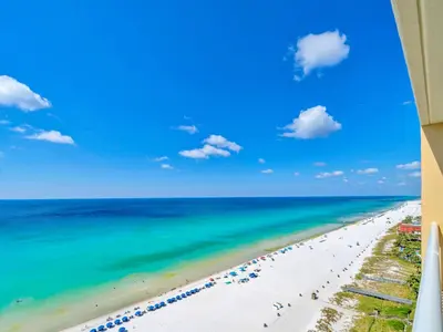 a view of the beach from the balcony of a resort at BeachFront- 5 Pools, Starbucks, Movies - Majestic Beach Resort in Panama City Beach