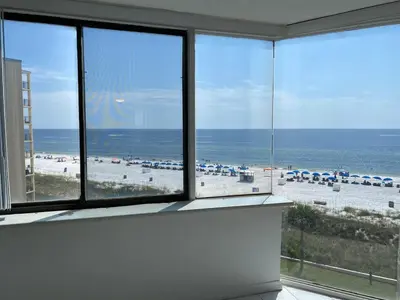 a view of a beach from a room with large windows at Best beachfront value in PCB! Incredible view! in Panama City Beach