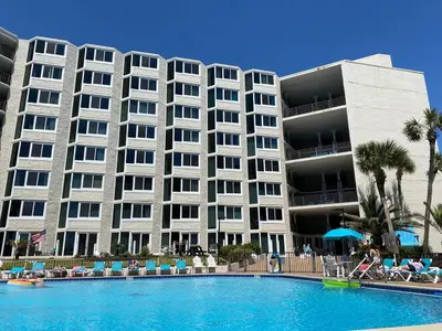 a large building with a swimming pool in front of it at Best beachfront value in PCB! Incredible view! in Panama City Beach