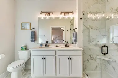 a white bathroom with a sink and a shower at Easy Beach Access New PCB Retreat with Resort Pool! in Panama City Beach