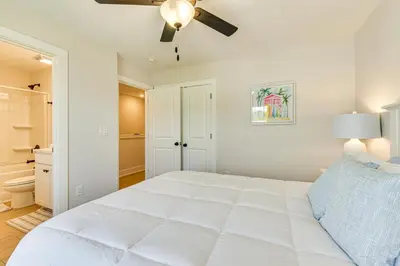 a white bedroom with a bed and a ceiling fan at Easy Beach Access New PCB Retreat with Resort Pool! in Panama City Beach