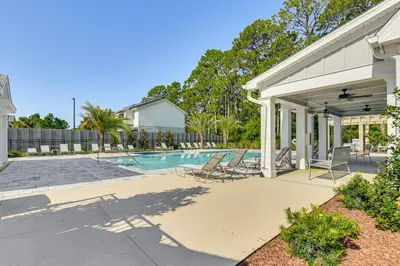 a house with a swimming pool in a yard at Easy Beach Access New PCB Retreat with Resort Pool! in Panama City Beach