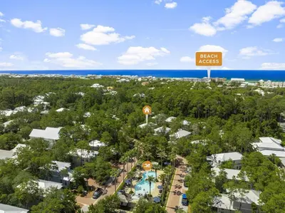 an aerial view of a resort with a pool and a sign at Sweet Sea-esta on 30A in Inlet Beach