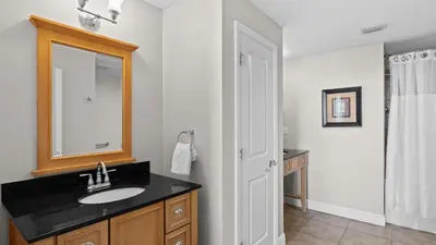 a bathroom with a sink and a mirror at 2 Beachfront Condos BBQ Balconies Resort Pool Hot Tub Direct Beach Access in Panama City Beach