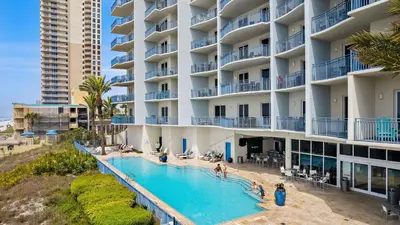 a swimming pool in front of a hotel at 2 Beachfront Condos BBQ Balconies Resort Pool Hot Tub Direct Beach Access in Panama City Beach