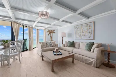 a living room with a couch and a table at Renovated Penthouse! Free Beach Chairs Included! by Dolce Vita Getaways PCB in Panama City Beach