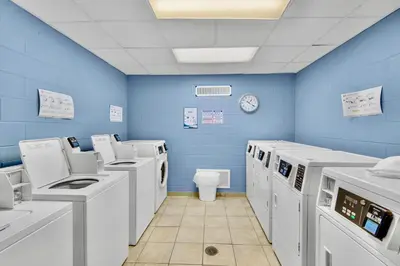 a blue room with washing machines and a toilet at Renovated Penthouse! Free Beach Chairs Included! by Dolce Vita Getaways PCB in Panama City Beach