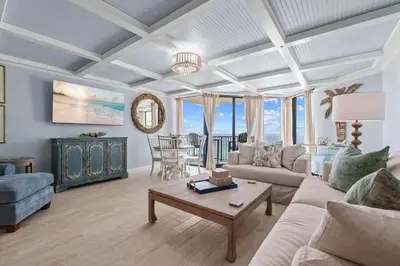a living room with a couch and a table at Renovated Penthouse! Free Beach Chairs Included! by Dolce Vita Getaways PCB in Panama City Beach