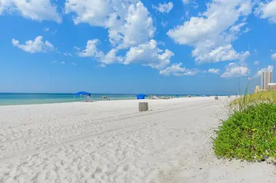 a white sandy beach with a view of the ocean at 3B - The Seaglass Shack in Panama City Beach