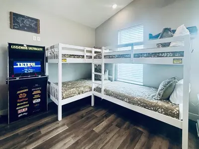 two bunk beds in a room with a tv at The Salty Blue in Panama City Beach