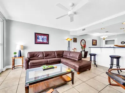a living room with a couch and a table at Treasure Island 1102 in Panama City Beach