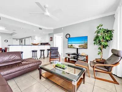 a living room with a couch and a table at Treasure Island 1102 in Panama City Beach