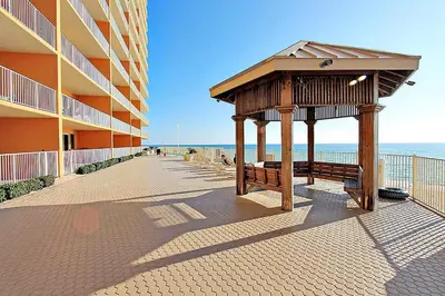 a gazebo next to a building next to the beach at Treasure Island 1102 in Panama City Beach