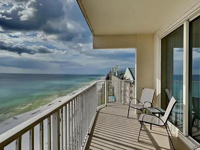 a balcony with chairs and a view of the beach at Shores of Panama #1501 in Panama City Beach