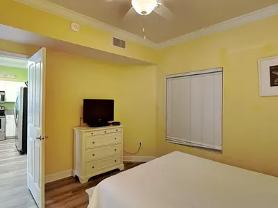 a bedroom with a bed and a tv on a dresser at Shores of Panama #1501 in Panama City Beach