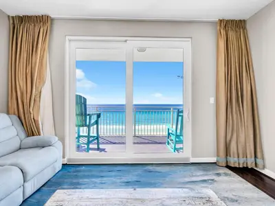 a living room with a couch and a view of the ocean at Sterling Reef 501 by Emerald Coast Reteats in Panama City Beach